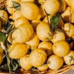 lemons in a basket, make sure to eat the lemon peels for all the health benefits!