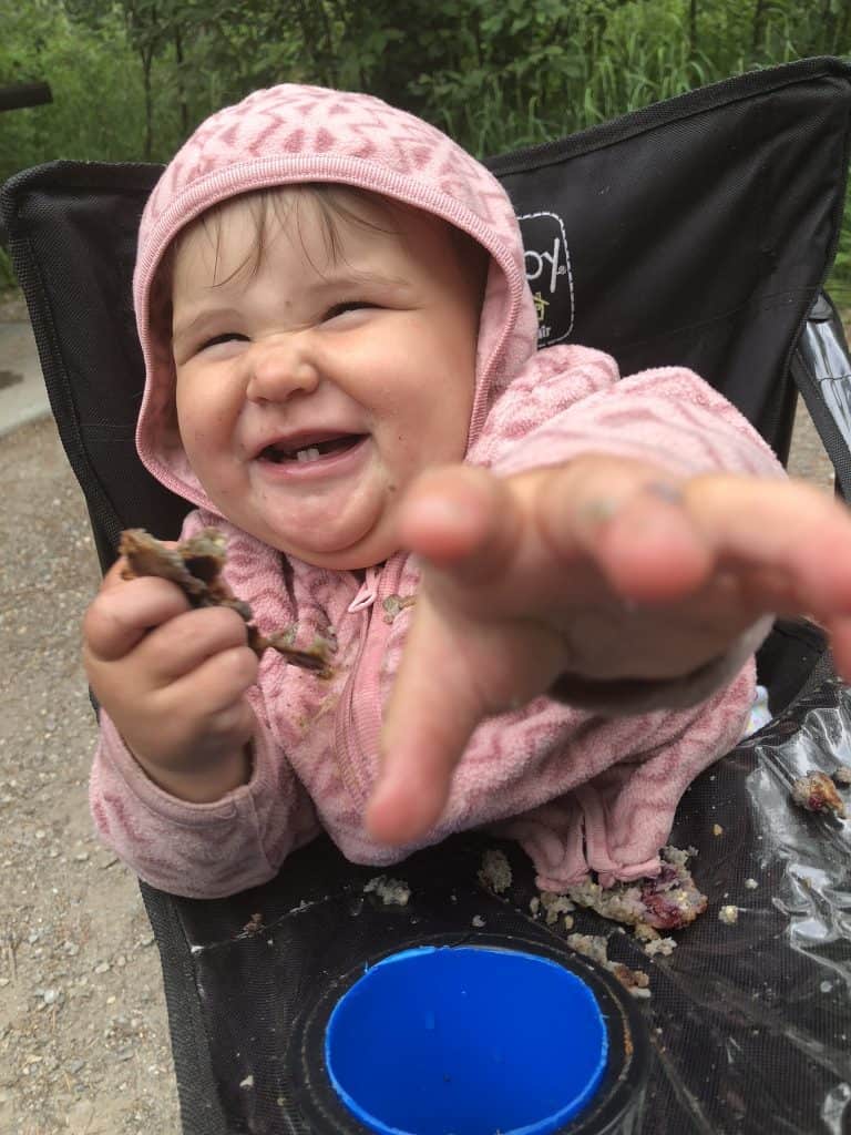 keeping babies busy around camp with food in a camping highchair