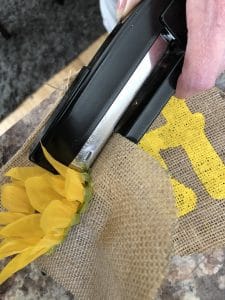 attach flowers to banner with a stapler 