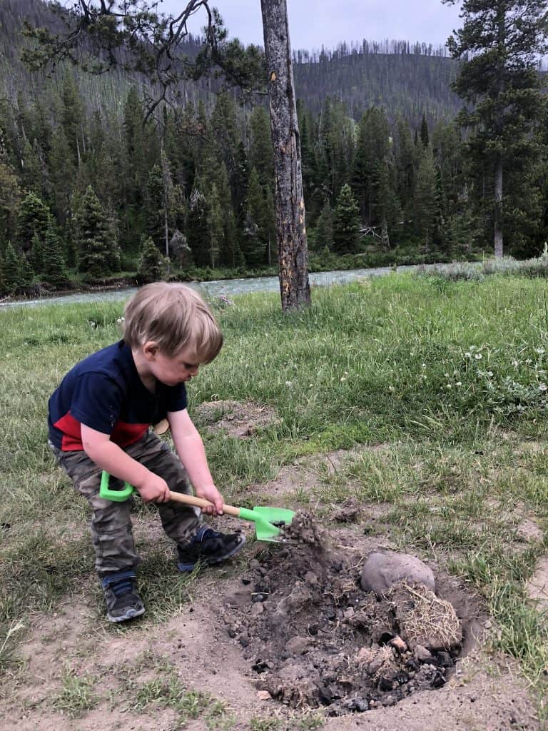 digging a hole for kids is a fun kids camping activity