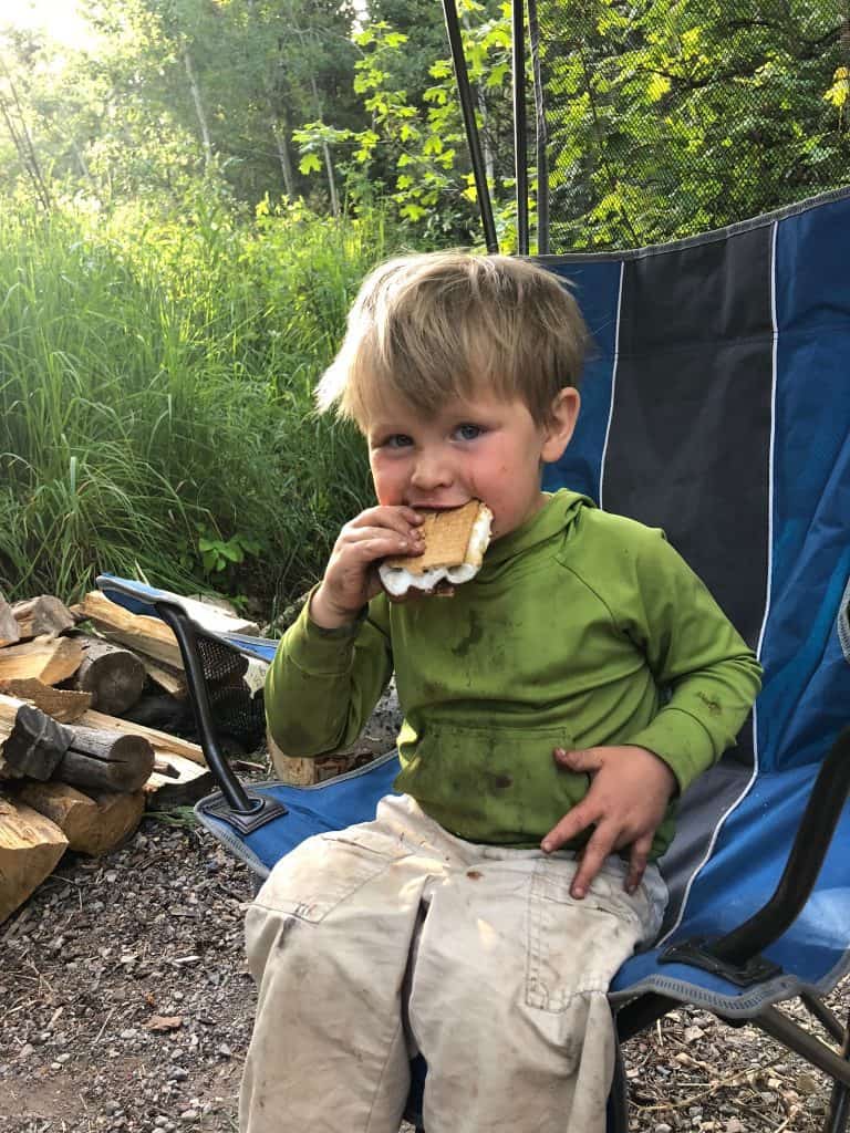 s'mores while camping to make it special for kids