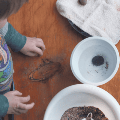 A fun and easy sensory bin using natural items thats fun for kids of all ages, especially preschoolers and older toddlers! This uses rocks, sand, as well as fine motor skills to retrieve and clean the rocks!