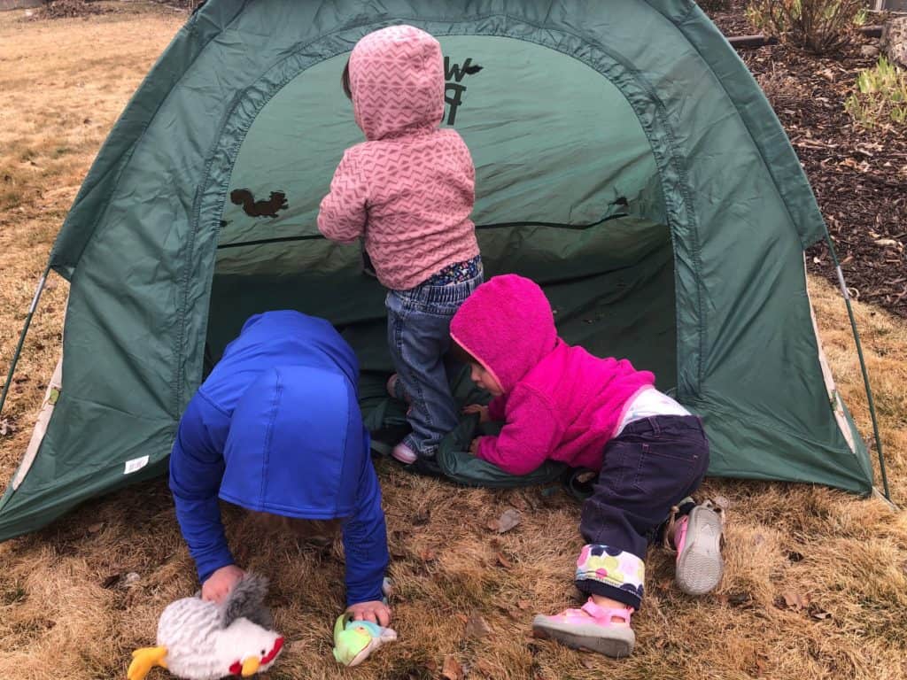 camping with kids tip - use a play tent for shade and to contain toys