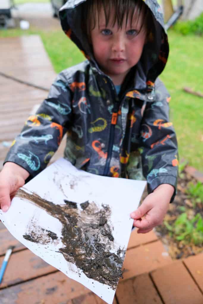 mud painting for rainy day fun outside with kids