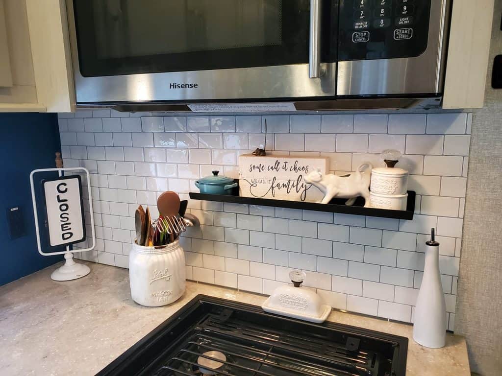 white subway tile in kitchen of camper