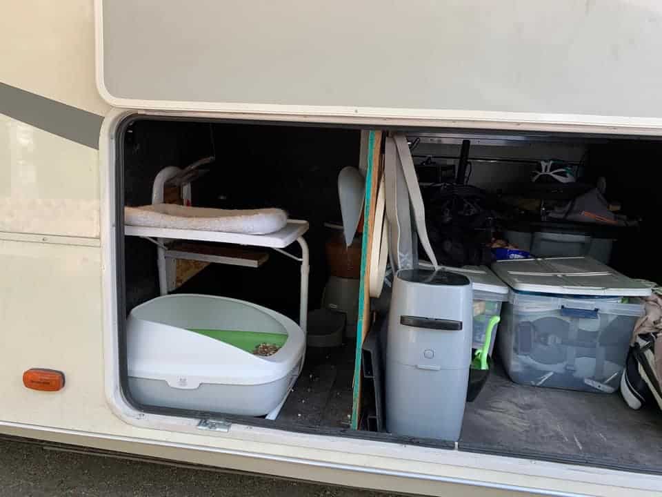 litter box in camper under storage basement area