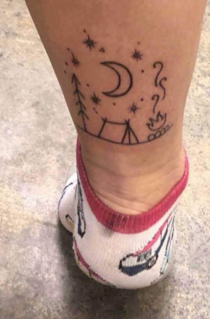 simple camping tattoo on leg