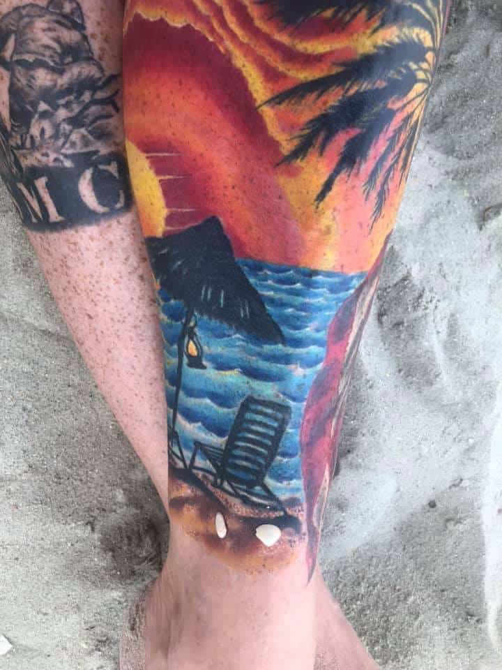 color beach tattoo on leg