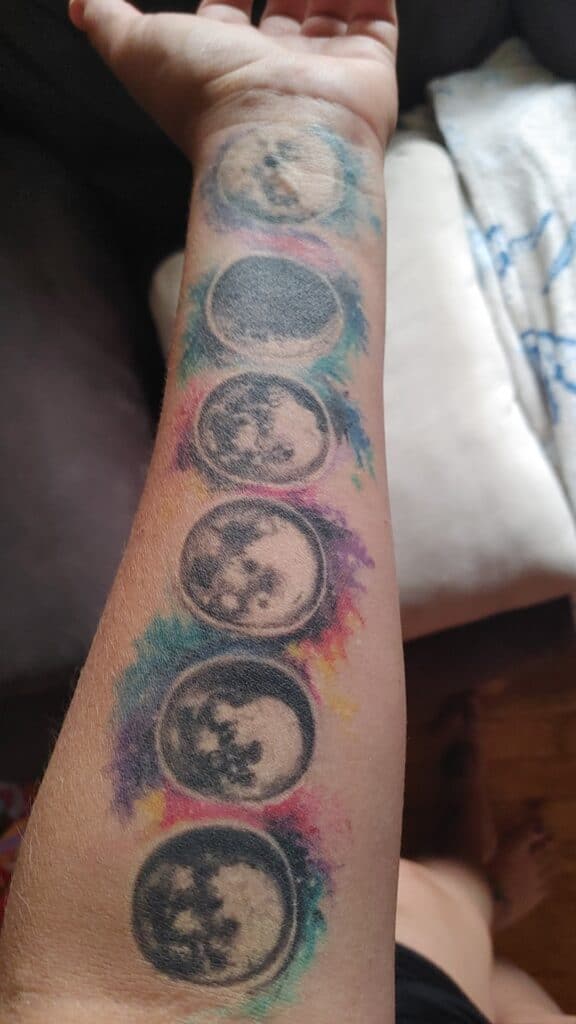 color moon phases tattoo on forearm