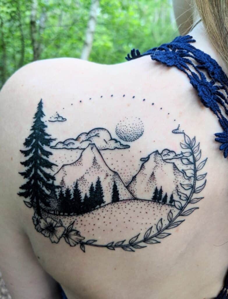 feminine minimal shoulder nature tattoo with mountains