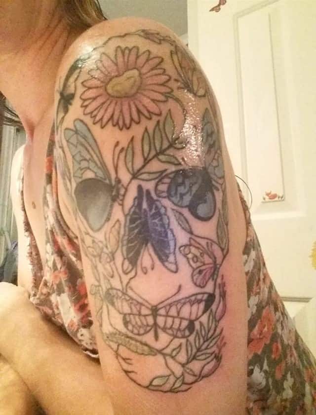 womens nature shoulder tattoo with skull made out of nature