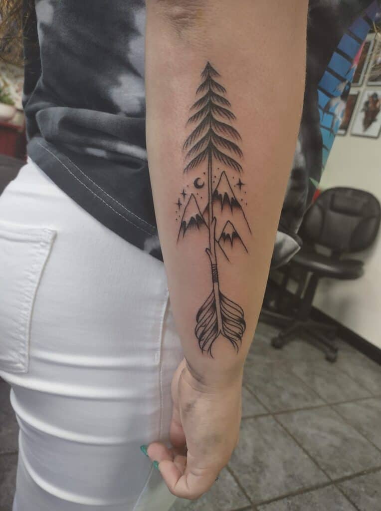 mountains arrow and tree forearm tattoo minimal simple