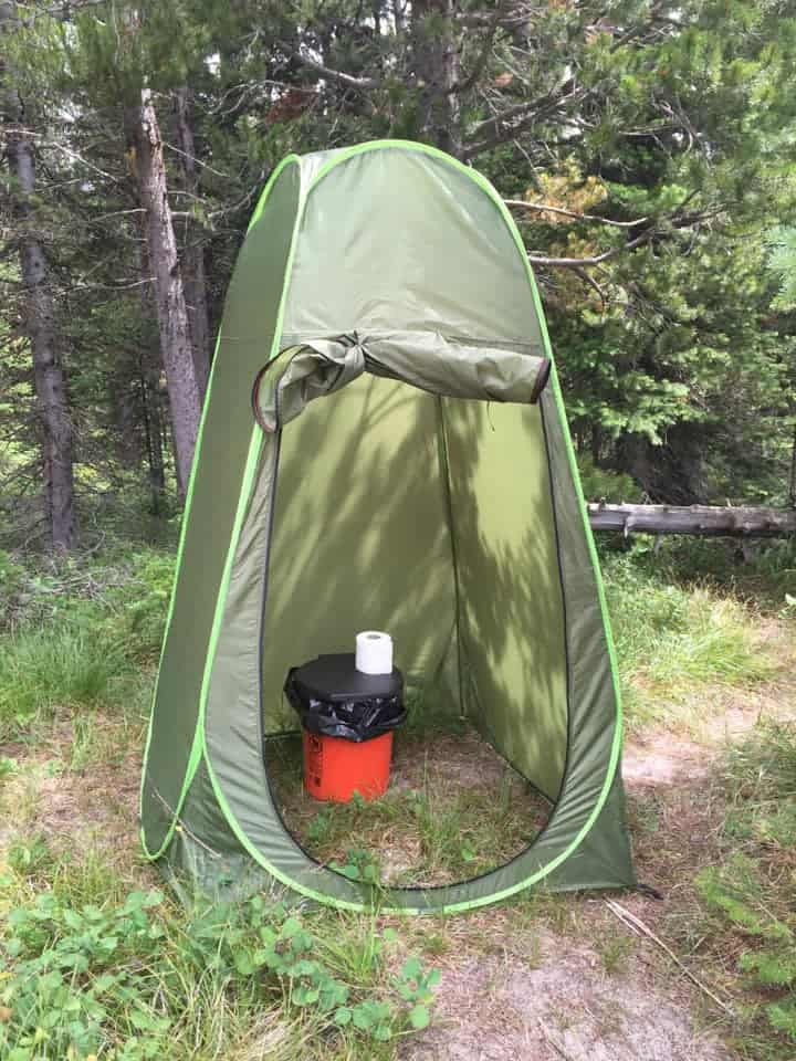green pop up privacy tent around 5 gallon bucket camp toilet