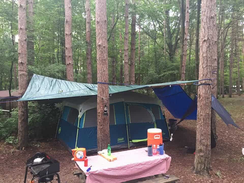 tent campsite setup with tarps for rain