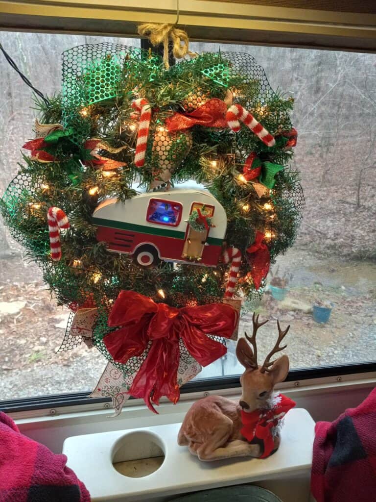camper themed wreath hanging on window