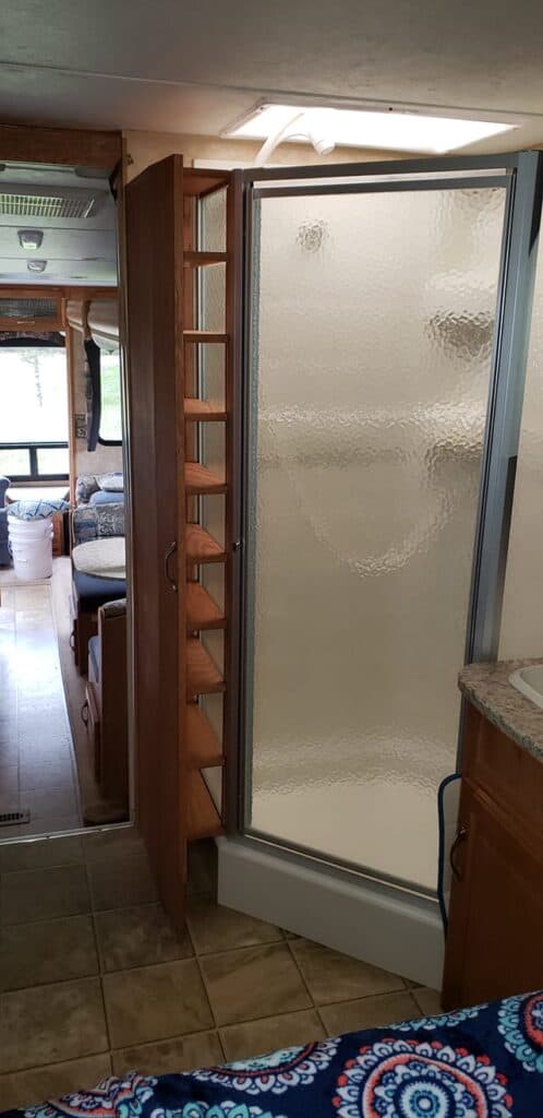 hidden space by shower of camper for shelves