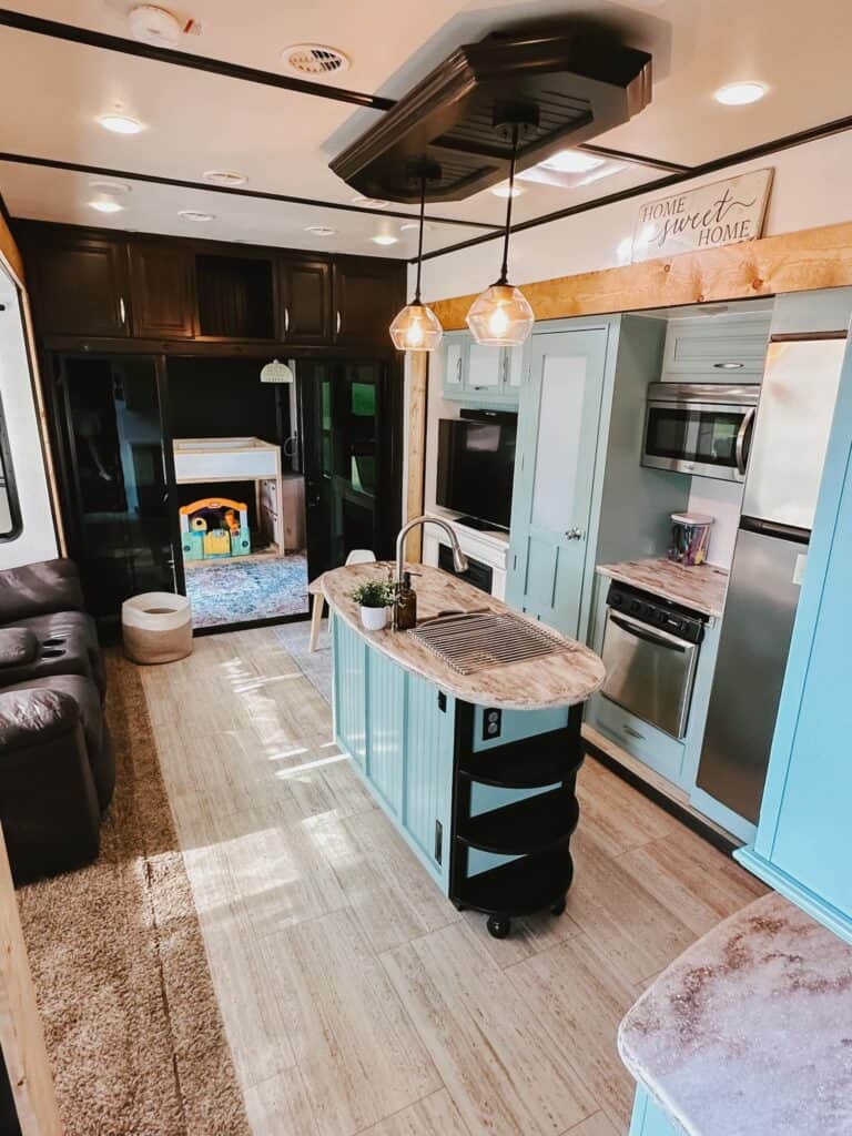 pastel blue painted camper interior with modern lighting
