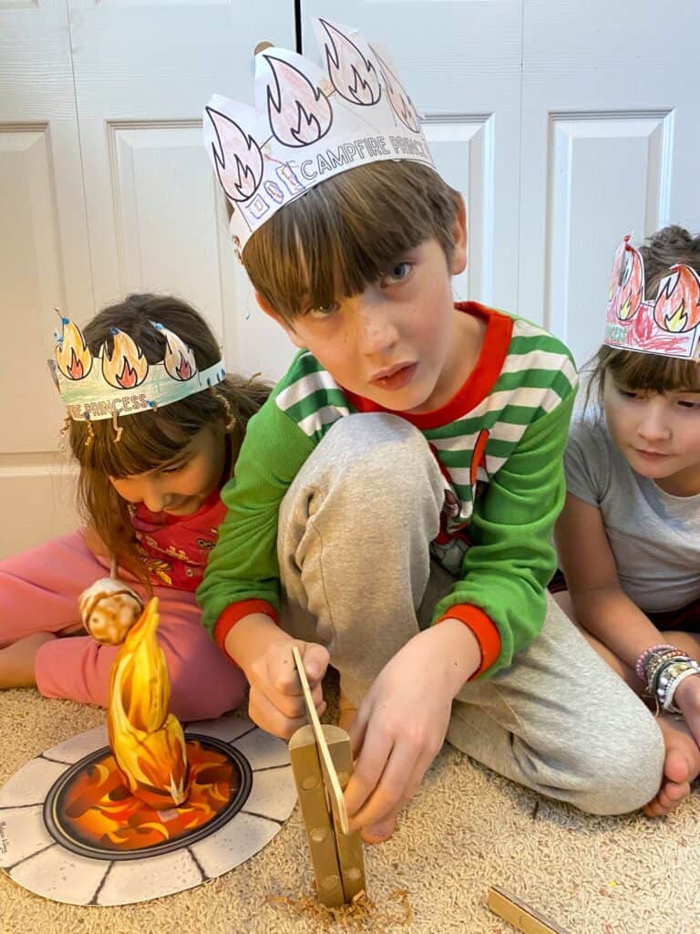 kids playing with pretend campfire wearing campfire crowns