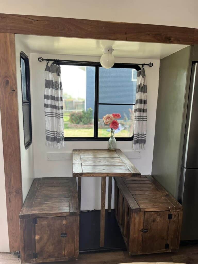 rustic themed camper interior with trunks as bench seats