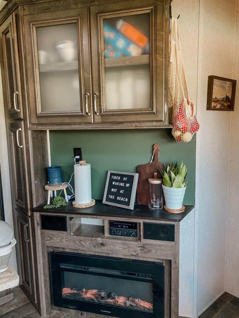 boho natural aesthetic camper interior with sage green, plants and wood elements