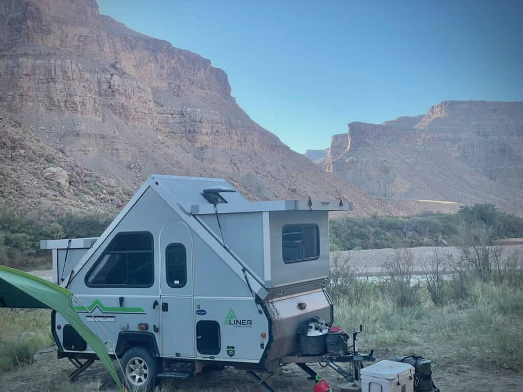 aliner camper in front of desert background