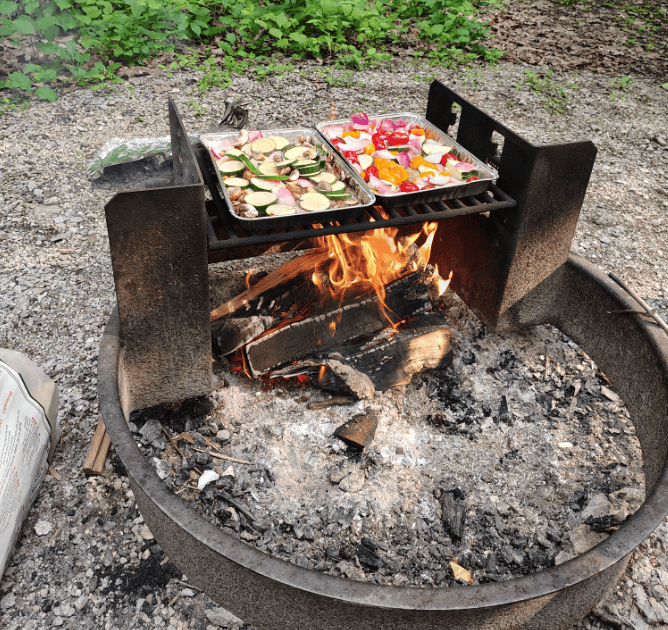 aluminum pans bought from the dollar tree being used to cook over a campfire and ahve easy clean up