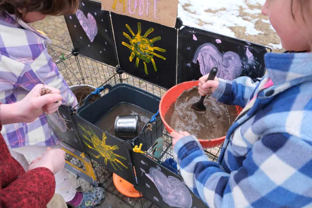 mud kitchen in use with mud in a bowl and a sink